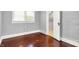 Cozy bedroom with hardwood floors, neutral gray paint, window, and closet space at 1511 E Edwards Ave, Indianapolis, IN 46227