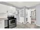 Bright kitchen with stainless steel appliances, updated cabinets, and access to bathroom at 1511 E Edwards Ave, Indianapolis, IN 46227