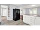 Kitchen with stainless steel appliances and newly updated white cabinets at 1511 E Edwards Ave, Indianapolis, IN 46227