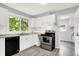 Updated kitchen featuring new cabinets and flooring with stainless appliances at 1511 E Edwards Ave, Indianapolis, IN 46227
