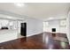 Open-concept living room with hardwood floors connected to updated kitchen at 1511 E Edwards Ave, Indianapolis, IN 46227