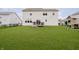 Spacious backyard with lush green grass, a black fence, and a playhouse at 15598 Memorial Way, Fishers, IN 46037