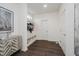 The foyer features sleek wood-look flooring and a storage bench with coat hooks to keep you organized at 15598 Memorial Way, Fishers, IN 46037