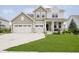 Charming two-story home with a well-manicured lawn, two-car garage and inviting front porch at 15598 Memorial Way, Fishers, IN 46037