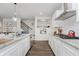 Bright kitchen features stainless appliances, dark wood floors, granite counters, and subway tile backsplash at 15598 Memorial Way, Fishers, IN 46037
