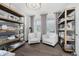Cozy sitting room with hardwood floors, built-in shelving, comfortable chairs, and bright natural light at 15598 Memorial Way, Fishers, IN 46037