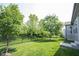 Fenced back yard with mature trees, and manicured lawn at 1590 Birchfield Dr, Westfield, IN 46074