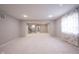 Carpeted basement with access to the stairs and a large window at 1590 Birchfield Dr, Westfield, IN 46074