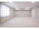Basement with large window and plush carpeting offers comfortable space at 1590 Birchfield Dr, Westfield, IN 46074