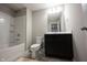 Bathroom featuring a shower, toilet, and vanity sink with dark cabinets at 1590 Birchfield Dr, Westfield, IN 46074