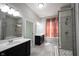 Modern bathroom featuring a luxurious walk-in shower, double vanity, and abundant natural light at 1590 Birchfield Dr, Westfield, IN 46074