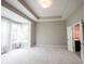 Bright bedroom featuring a tray ceiling, neutral walls, and bright natural light from multiple windows at 1590 Birchfield Dr, Westfield, IN 46074
