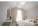 Stylishly decorated bedroom with a vaulted ceiling, oval mirror, and warm lighting at 1590 Birchfield Dr, Westfield, IN 46074