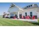 View of the clubhouse exterior with red rocking chairs on the veranda and manicured lawn at 1590 Birchfield Dr, Westfield, IN 46074
