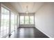 Open dining area with modern light fixture and a sliding glass door to the outside patio at 1590 Birchfield Dr, Westfield, IN 46074
