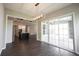 Dining room with a view of the kitchen, featuring modern light fixtures and hardwood floors at 1590 Birchfield Dr, Westfield, IN 46074