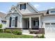 Beautiful craftsman-style home with a covered porch, brick accents, and a well-maintained front yard at 1590 Birchfield Dr, Westfield, IN 46074