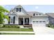 Charming home featuring a well-manicured lawn, a two-car garage, and a welcoming front porch at 1590 Birchfield Dr, Westfield, IN 46074
