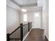 Bright foyer with hardwood floors, elegant lighting, and a staircase with black railing at 1590 Birchfield Dr, Westfield, IN 46074
