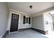 Relaxing front porch featuring chairs, a side table, and a stylish entrance door at 1590 Birchfield Dr, Westfield, IN 46074