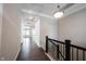 Hallway with hardwood floors leading to a bright room with large windows, and detailed crown moulding at 1590 Birchfield Dr, Westfield, IN 46074