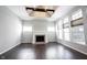Bright, open living room with fireplace, large windows, and dark wood floors at 1590 Birchfield Dr, Westfield, IN 46074