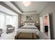 Stylized main bedroom boasts ample natural light, a neutral color palette, and a peaceful ambiance at 1590 Birchfield Dr, Westfield, IN 46074