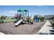 Community playground featuring play structures, slides and swings with homes in background at 1590 Birchfield Dr, Westfield, IN 46074