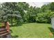Large backyard with wooden deck and mature trees at 1727 S Irvington Ave, Indianapolis, IN 46203