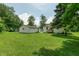 Lush backyard with detached garage and trees providing shade at 1727 S Irvington Ave, Indianapolis, IN 46203