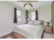 Comfortable bedroom with two windows, ceiling fan and neutral tones at 1727 S Irvington Ave, Indianapolis, IN 46203