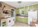 Bright, vintage-style kitchen featuring green cabinets and classic appliances at 1727 S Irvington Ave, Indianapolis, IN 46203
