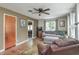 Cozy living room featuring neutral wall colors, a ceiling fan, hardwood floors, and natural light at 1727 S Irvington Ave, Indianapolis, IN 46203