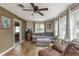 Comfortable living room with a plush gray sofa, wood flooring, and large windows at 1727 S Irvington Ave, Indianapolis, IN 46203
