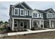 Modern townhomes with gray and white siding, stone accents, and covered entryways at 19571 Grassy Branch Dr, Westfield, IN 46074