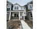 Charming townhome with white siding, stone accents, covered porch, and sidewalk at 19571 Grassy Branch Dr, Westfield, IN 46074