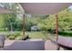 Inviting backyard with a covered patio, hammock, flowerbeds, and a peaceful ambiance at 214 W Stoney Trl, Greenfield, IN 46140