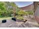 Beautiful backyard featuring a patio with awning, landscaping, and a lush green lawn at 214 W Stoney Trl, Greenfield, IN 46140