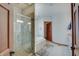 Bright bathroom with a glass shower, soaking tub, and neutral tile at 214 W Stoney Trl, Greenfield, IN 46140