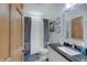 Clean bathroom with black countertop, shower with curtain, and neutral wall art at 214 W Stoney Trl, Greenfield, IN 46140