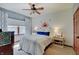 Well lit bedroom with modern ceiling fan and large window at 214 W Stoney Trl, Greenfield, IN 46140