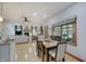 Dining area with a large window, wood trim, and views of the fireplace and living room at 214 W Stoney Trl, Greenfield, IN 46140