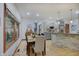 Open dining area with a view into a kitchen featuring gray cabinets and stainless appliances at 214 W Stoney Trl, Greenfield, IN 46140