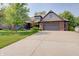 Charming brick home boasts an attached two-car garage and lush landscaping at 214 W Stoney Trl, Greenfield, IN 46140