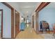 Bright hallway showcasing wood trim, hardwood floors, and decorative furniture at 214 W Stoney Trl, Greenfield, IN 46140