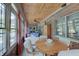 Sunroom with brick walls, wood ceiling, and lots of windows for natural light at 214 W Stoney Trl, Greenfield, IN 46140