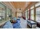 Relaxing sunroom features brick walls, wood ceiling and lots of natural light at 214 W Stoney Trl, Greenfield, IN 46140