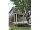 Side view of a two-story home with a covered front porch and dark green siding, showcasing its architectural design at 2148 N Pennsylvania St, Indianapolis, IN 46202