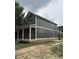 Two-story home with dark green siding and white trim, complemented by a covered front porch, set on a spacious lot at 2148 N Pennsylvania St, Indianapolis, IN 46202