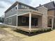 View of a two-story home featuring a covered deck area with a brick fireplace, perfect for outdoor entertaining at 2148 N Pennsylvania St, Indianapolis, IN 46202